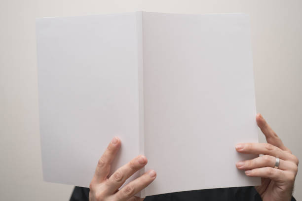 istock male hands holding a blank white notebook mock-up 843700336