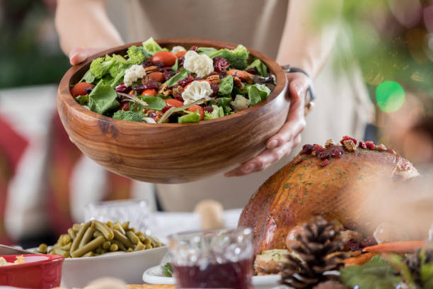 istock Christmas dinner hostess offers salad 843702404