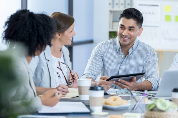 Businessman uses digital tablet during meeting
