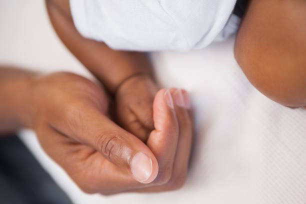 istock Baby boy sleeping peacefully on couch with father 843706254