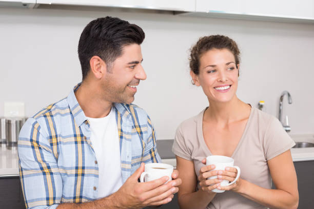 istock Attractive couple sitting having coffee together 843713890