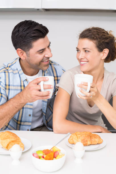 istock Attractive couple sitting having breakfast together 843713946