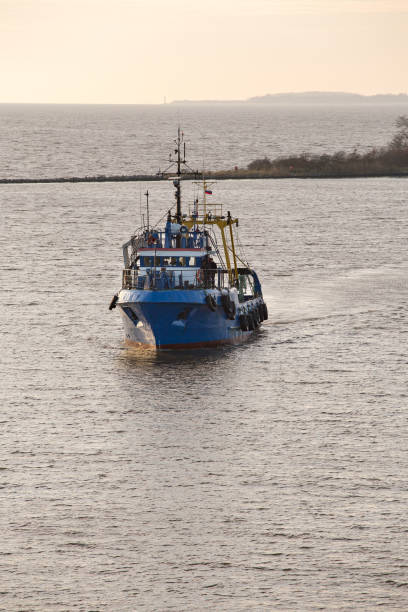 istock fishing vessel in a channel in a river 843716418