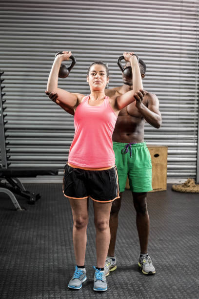 istock Fit couple lifting dumbbells 843720924