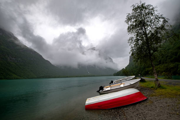 istock The Norwegian landscape with a boat on lake against mountains. 843728096