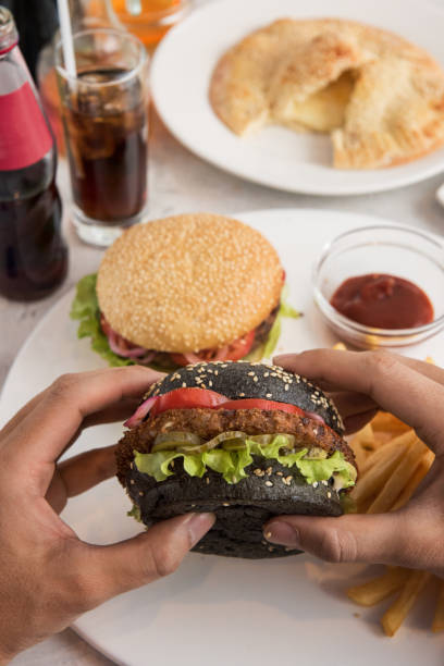 istock Man eating burgers 843728398
