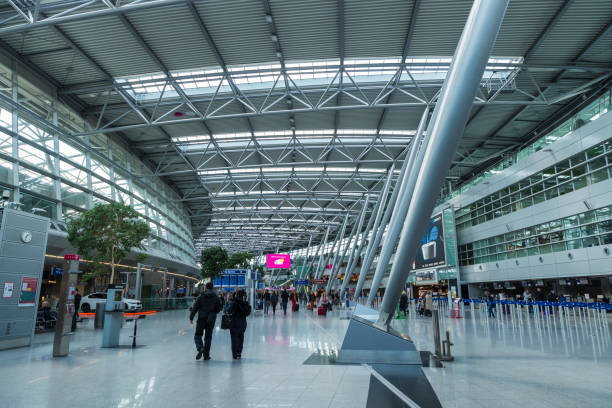 Dusseldorf: Interior of Dusseldorf airport with people walking in Dusseldorf, Germany