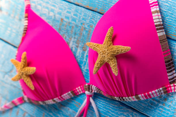 istock Beauty pink bikini on rustic wooden table 843733148