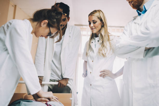 Group of medical students practicing reanimation task on model