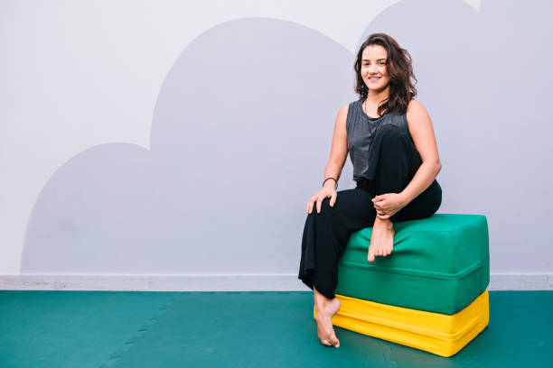 istock Young woman sitting on exercise mattress. 843741088