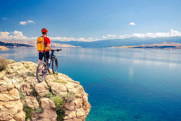 istock Mountain biker looking at view and riding a bike 843745044