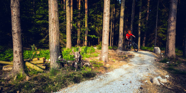 Mountain biker riding on bike in spring inspirational mountains landscape. Man cycling MTB on enduro trail track. Sport fitness motivation and inspiration.