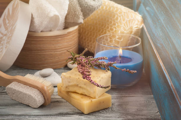 istock SPA composition with towels, soap, brush, lit candle 843747804