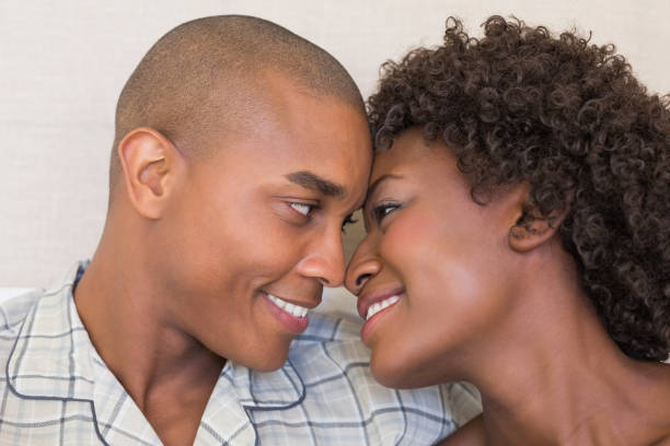 istock Happy couple sitting on bed cuddling 843747820
