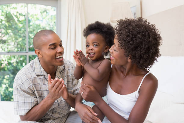 istock Happy couple on bed with baby daughter 843748670