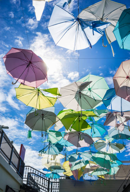 istock Street decorated with pastel colored umbrellas in sunny day 843749328