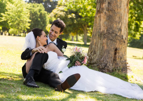 istock Happy newlywed couple relaxing in park 843752262