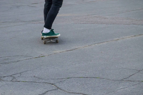 istock Skateboarder legs riding skateboard at skatepark 843753002