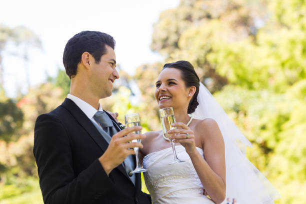 istock Happy newlywed toasting champagne flutes at park 843753804
