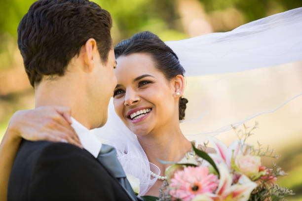 istock Romantic newlywed looking at each other in park 843755302