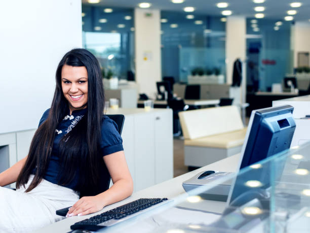 istock Smiling business woman working at computer. 843757148