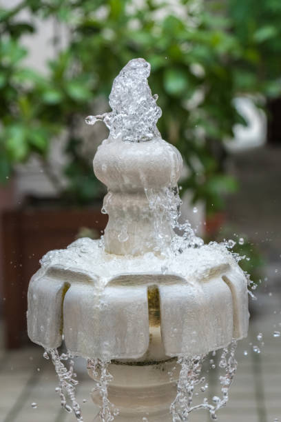 istock Close up water drops flowing from fountain 843760504
