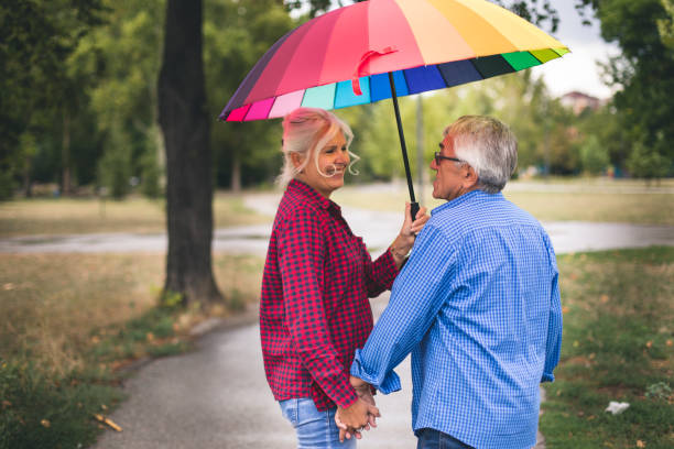 istock Couple with a rainbow umbrella 843760570