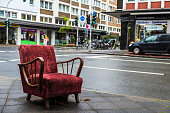 Old armchair vintage garnet lying on the street