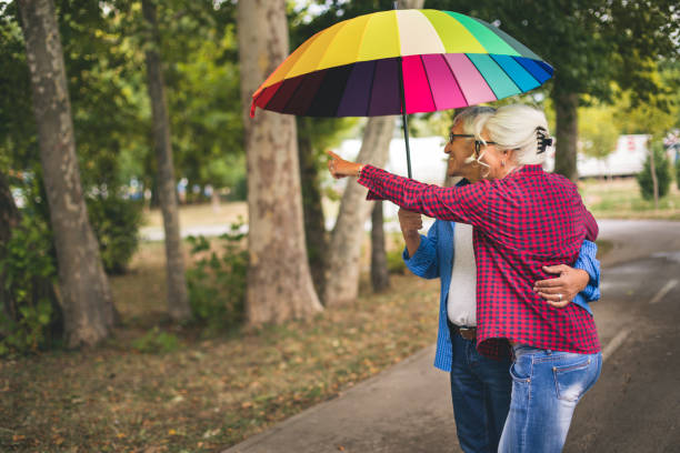 istock Couple with a rainbow umbrella 843764856