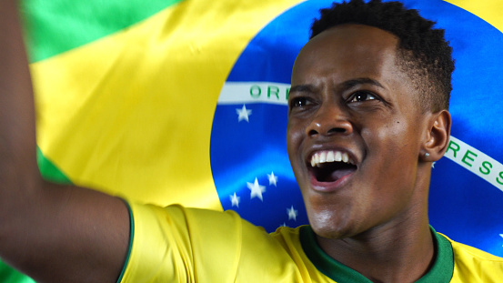 Brazilian Young Black Man Celebrating with Brazil Flag