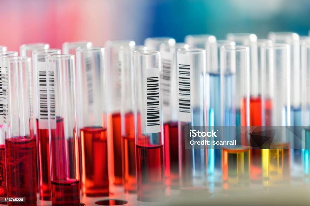 Test tubes in chemical laboratory Creative abstract chemistry development, medicine, pharmacy, biology, biochemistry and research technology concept: macro view of the row of glass test tubes with color liquid substances in the chemical laboratory with selective focus effect Pharmaceutical Manufacturing Machine Stock Photo
