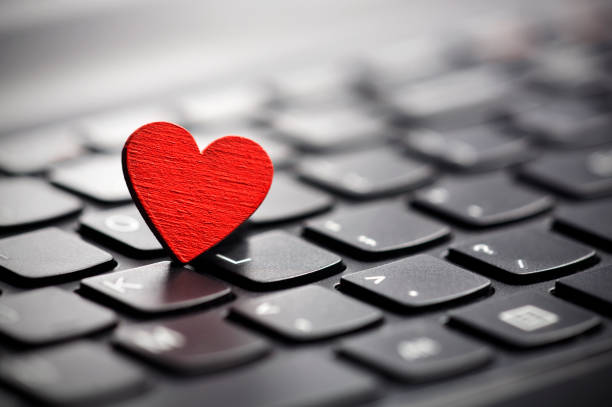 istock Small red heart on keyboard. Internet dating concept. 843765590