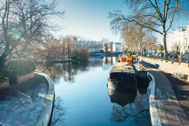 Boat in the canal View of a houseboat in a channel at Little Venice in London little venice london stock pictures, royalty-free photos & images