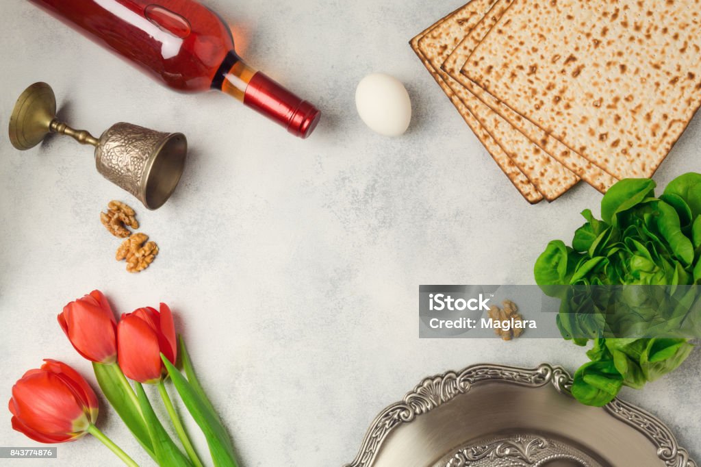 Passover holiday concept seder plate, matzoh and wine bottle on bright background. Top view from above Above Stock Photo