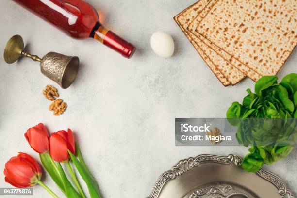 Passover Holiday Concept Seder Plate Matzoh And Wine Bottle On Bright Background Top View From Above Stock Photo - Download Image Now