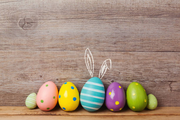 istock Easter holiday concept with eggs decorations over wooden background 843775036