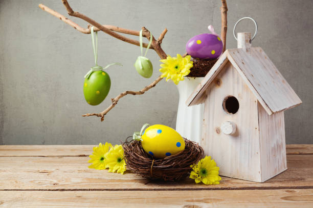 istock Easter holiday concept with eggs decorations and bird house over rustic background 843775074
