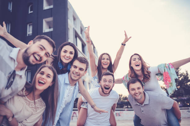 istock Young Smiling Couples Having Fun in City with Piggyback Ride 843775088