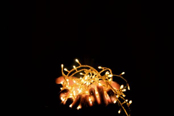 istock Christmas lights in the hands 843775682