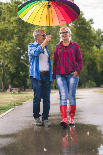 istock Couple with a rainbow umbrella 843777484