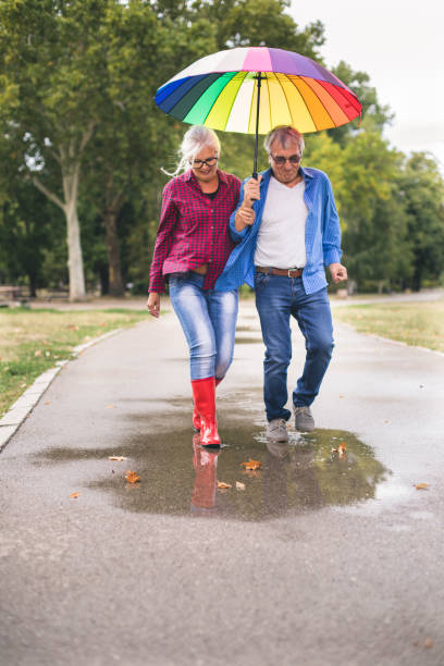 istock Couple with a rainbow umbrella 843778268