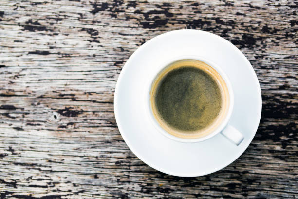 istock Coffee cup on wooden table background, top view 843782084