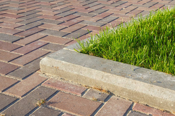 istock road and lawn divided by a concrete curb 843784806