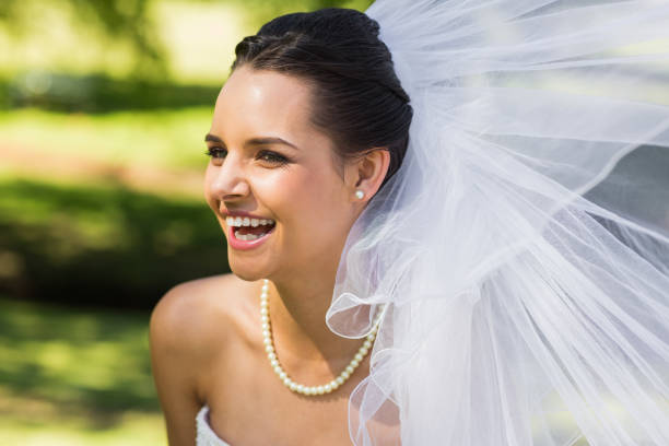 istock Cheerful young beautiful bride in park 843786672