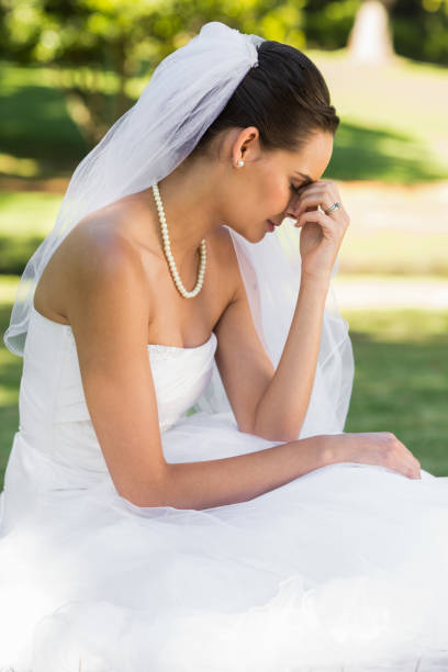 istock Beautiful worried bride sitting at park 843786888