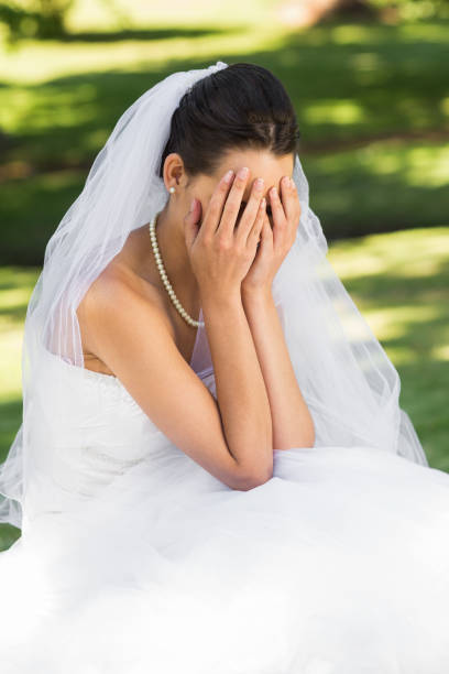 istock Beautiful worried bride sitting at park 843786944