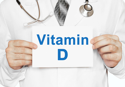 Doctor holding a card with Vitamin D, Medical concept