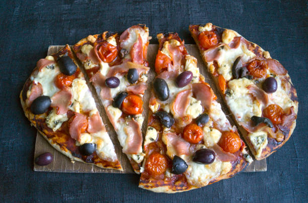 istock Cut into slices of delicious fresh pizza. 843793482