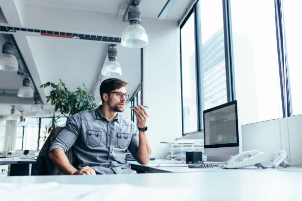 istock Young businessman talking on mobile phone in office 843793814