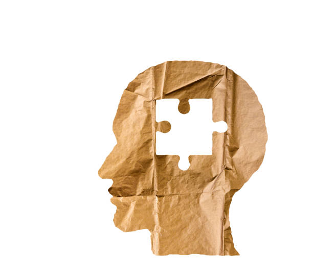 istock Crumpled paper shaped as a human head and puzzle on white background. Puzzle concept. 843796748